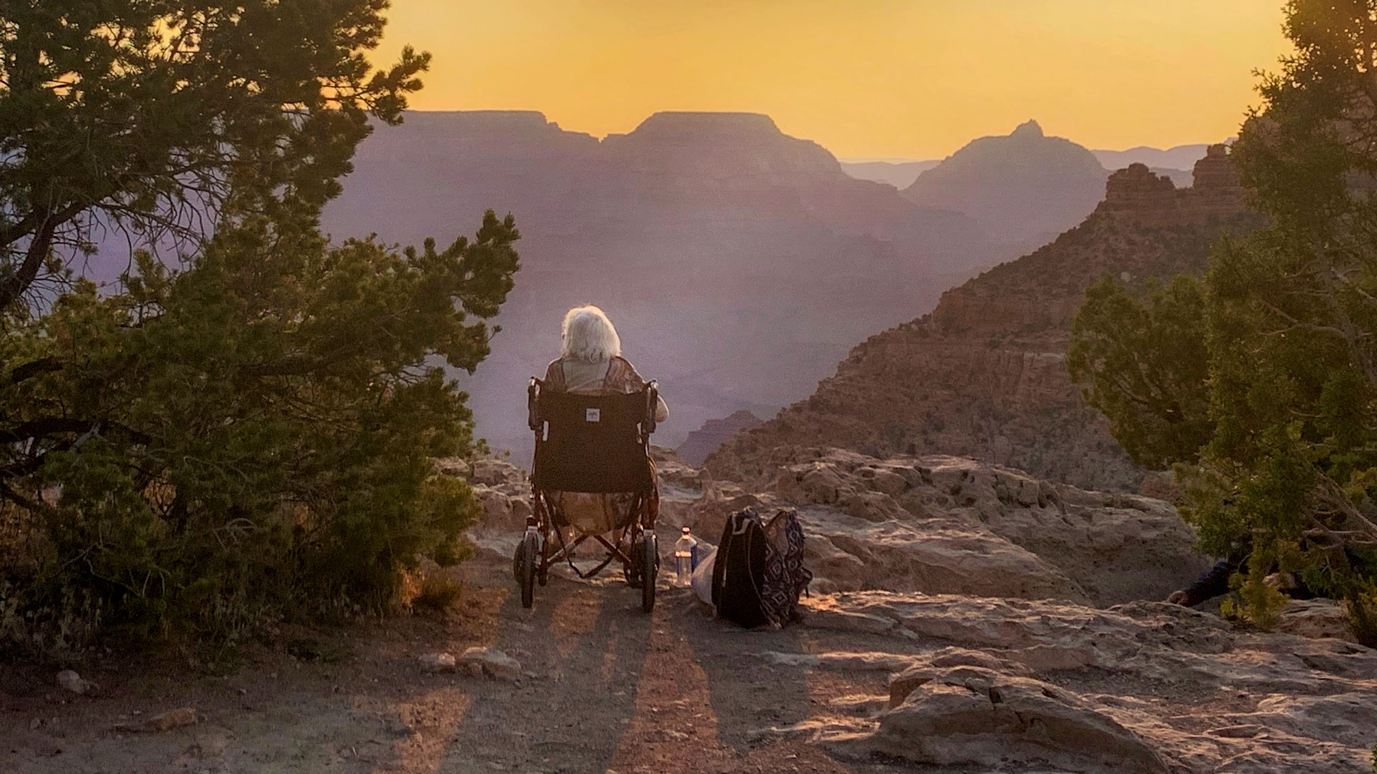 Wheelchair user at Grand Canyon looks at sunset
