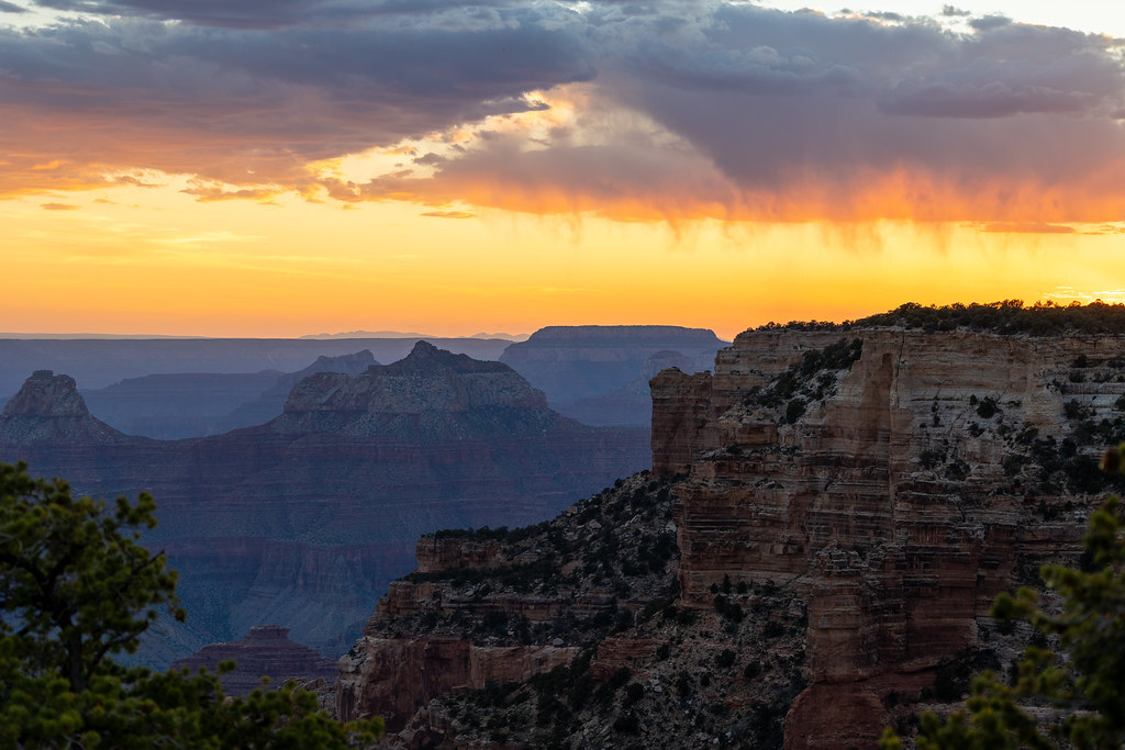 A dramatic sky of yellows and orange colors over the canyon