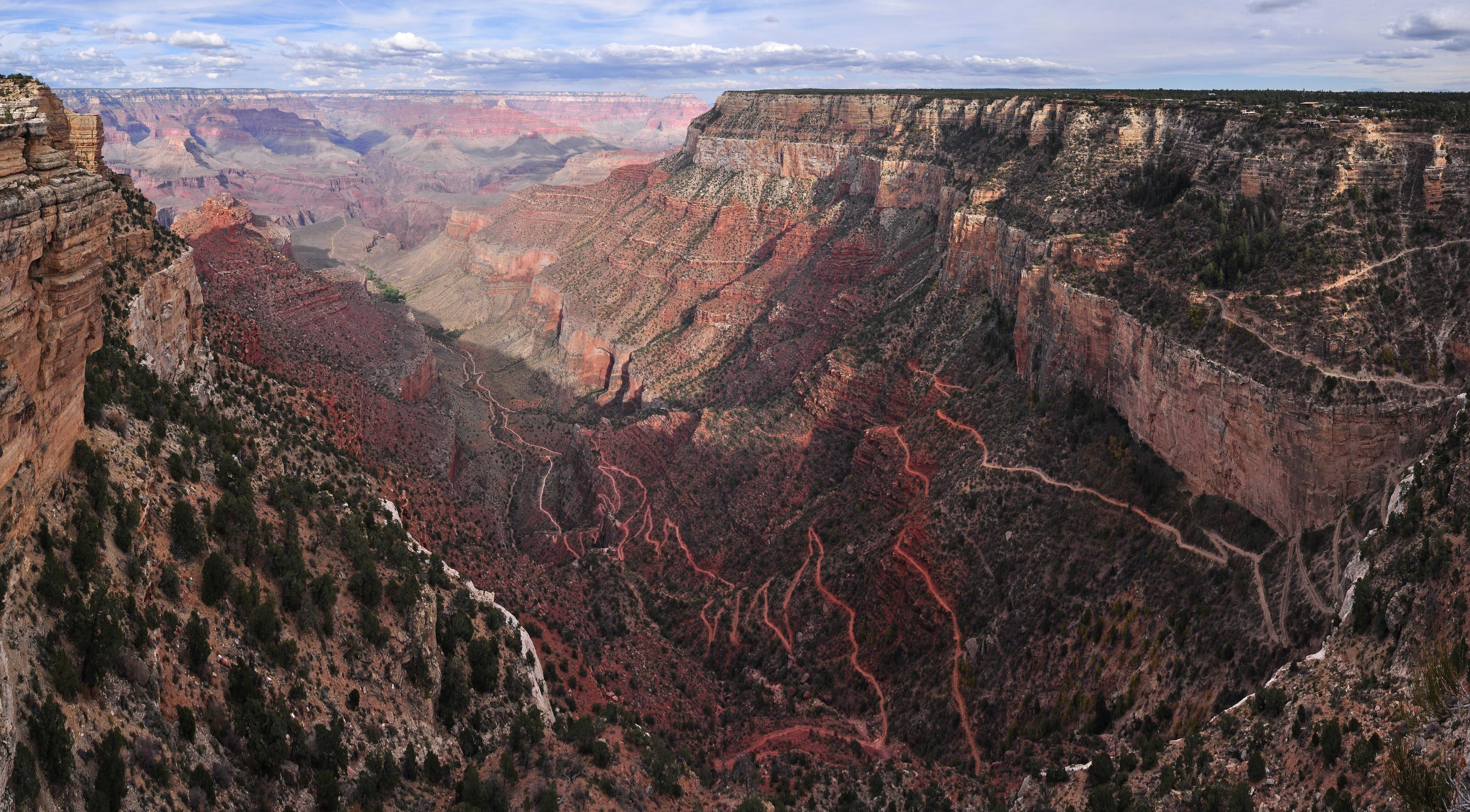 Grand Canyon National Park: Hermit Rd First Trail View
View to the northeast from First Trail View along the Hermit Road (West Rim Drive) on the South Rim of Grand Canyon National Park. Several sets of stairs access two main viewing areas. This viewpoint offers a spectacular view of the Bright Angel Trail switchbacking through the canyon below. Also visible, along the rim, is the Historic District of Grand Canyon Village, including the prominent El Tovar Hotel. This is the first overlook on the Hermit Road, 0.7 miles, 1.1 km from Grand Canyon Village via the paved footpath. NPS Photo by Michael Quinn.
