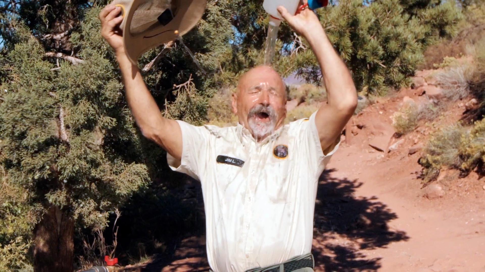 Volunteer dumping water on his head