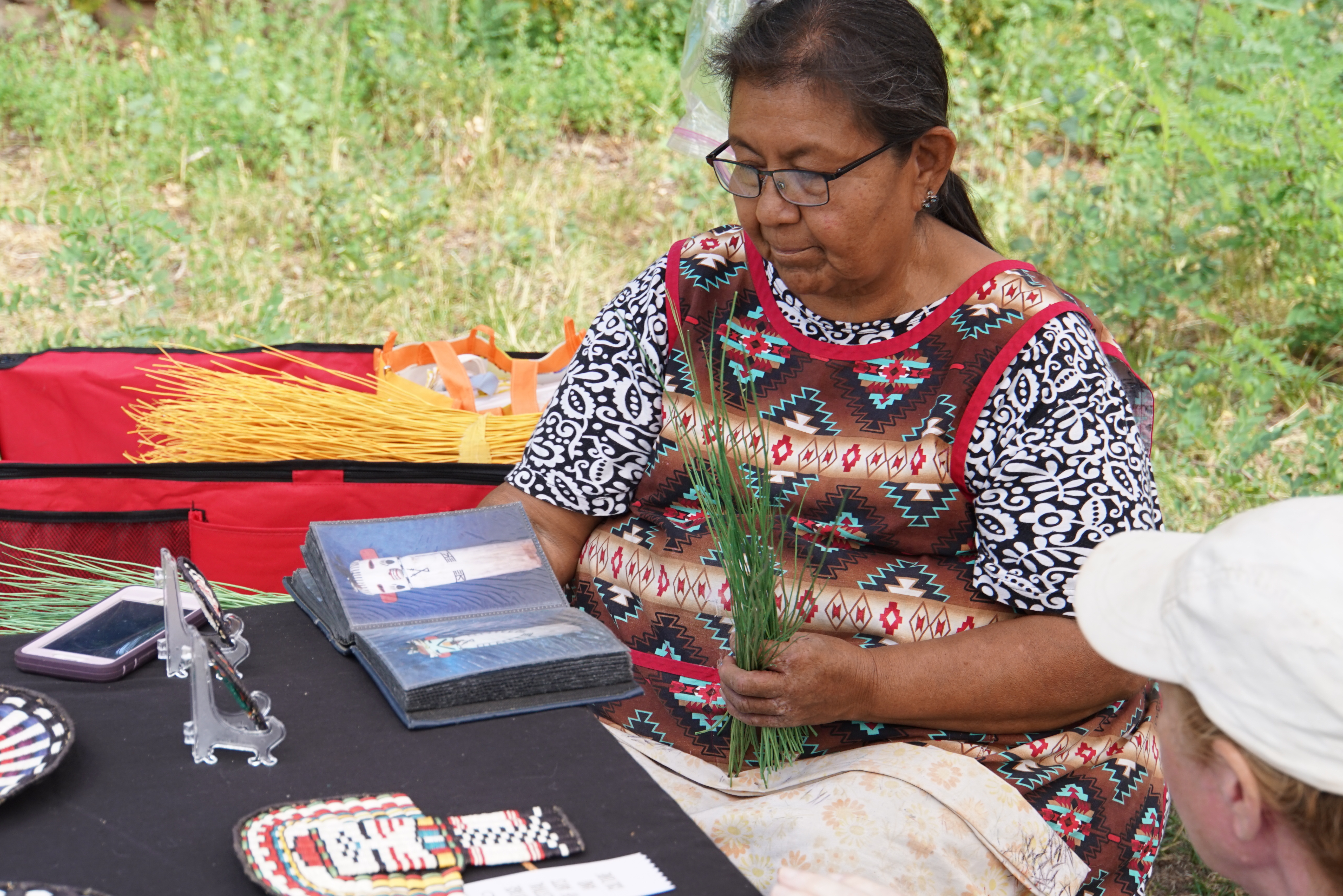 A hopi woman weaves a basket