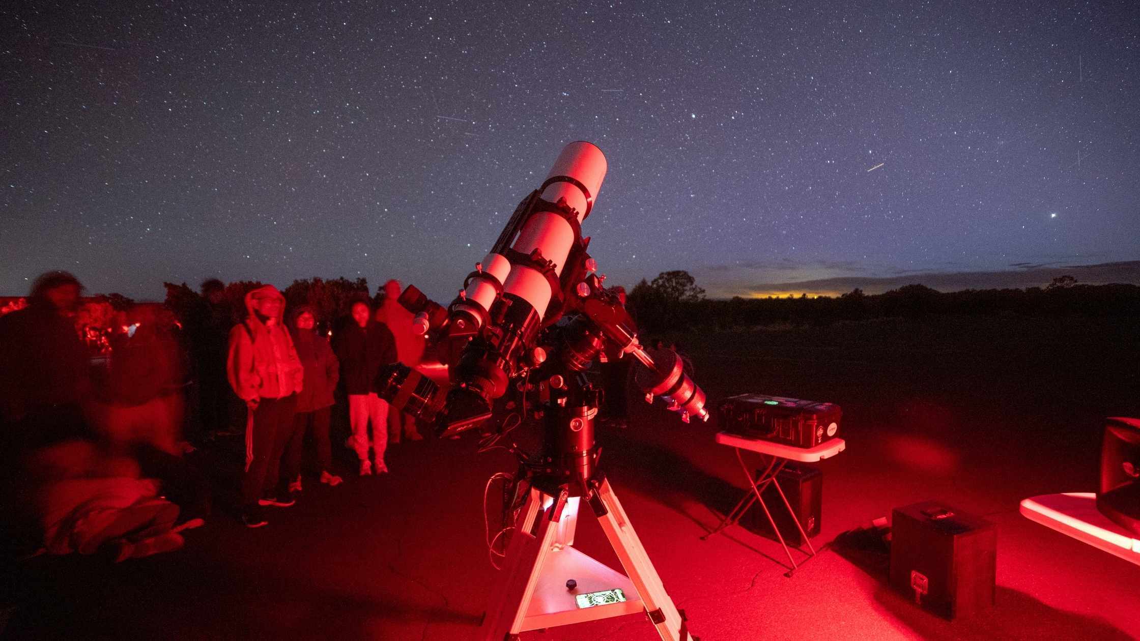 Professional telescope looking out at the night sky above Grand Canyon
