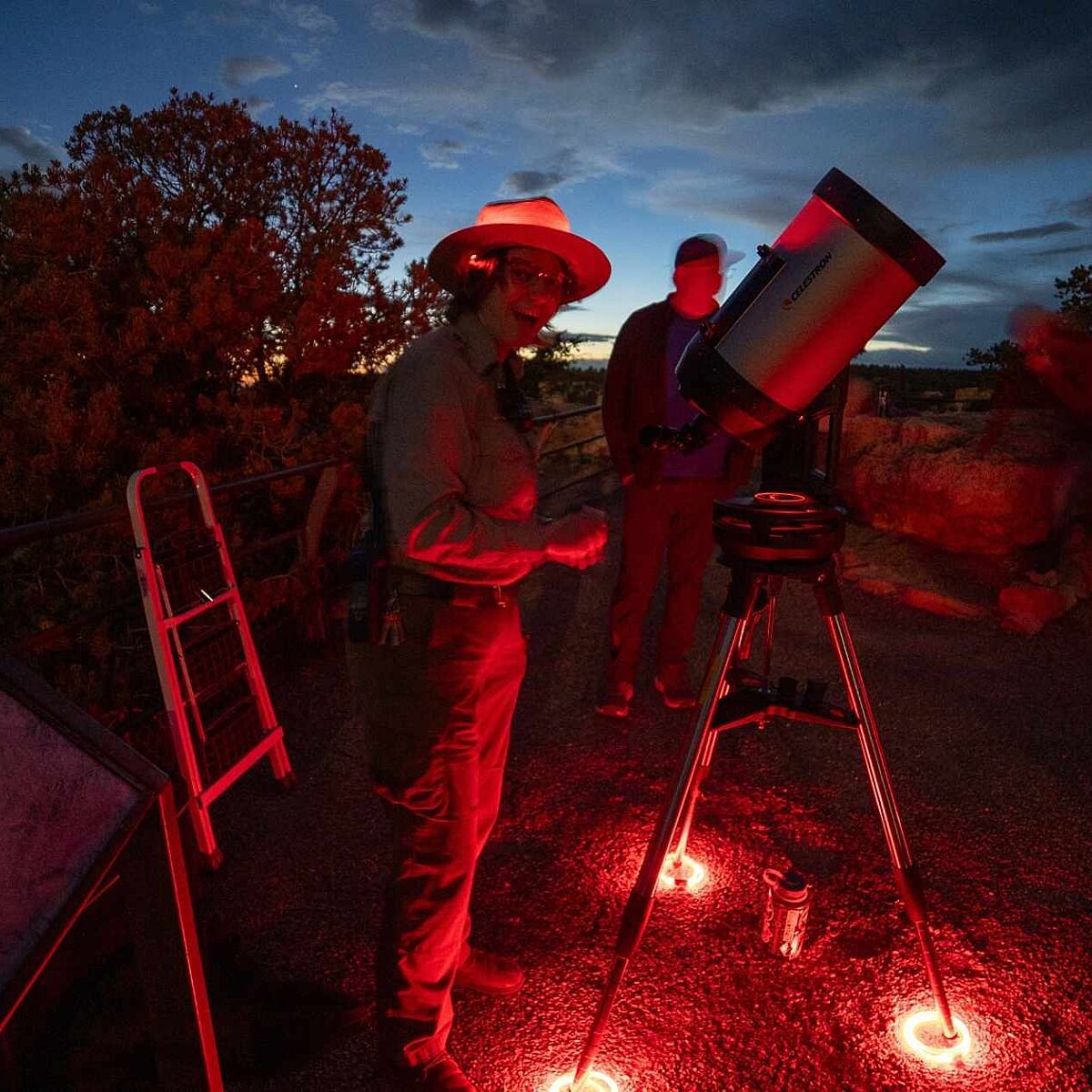 Astronomer looking through telescope at Grand Canyon