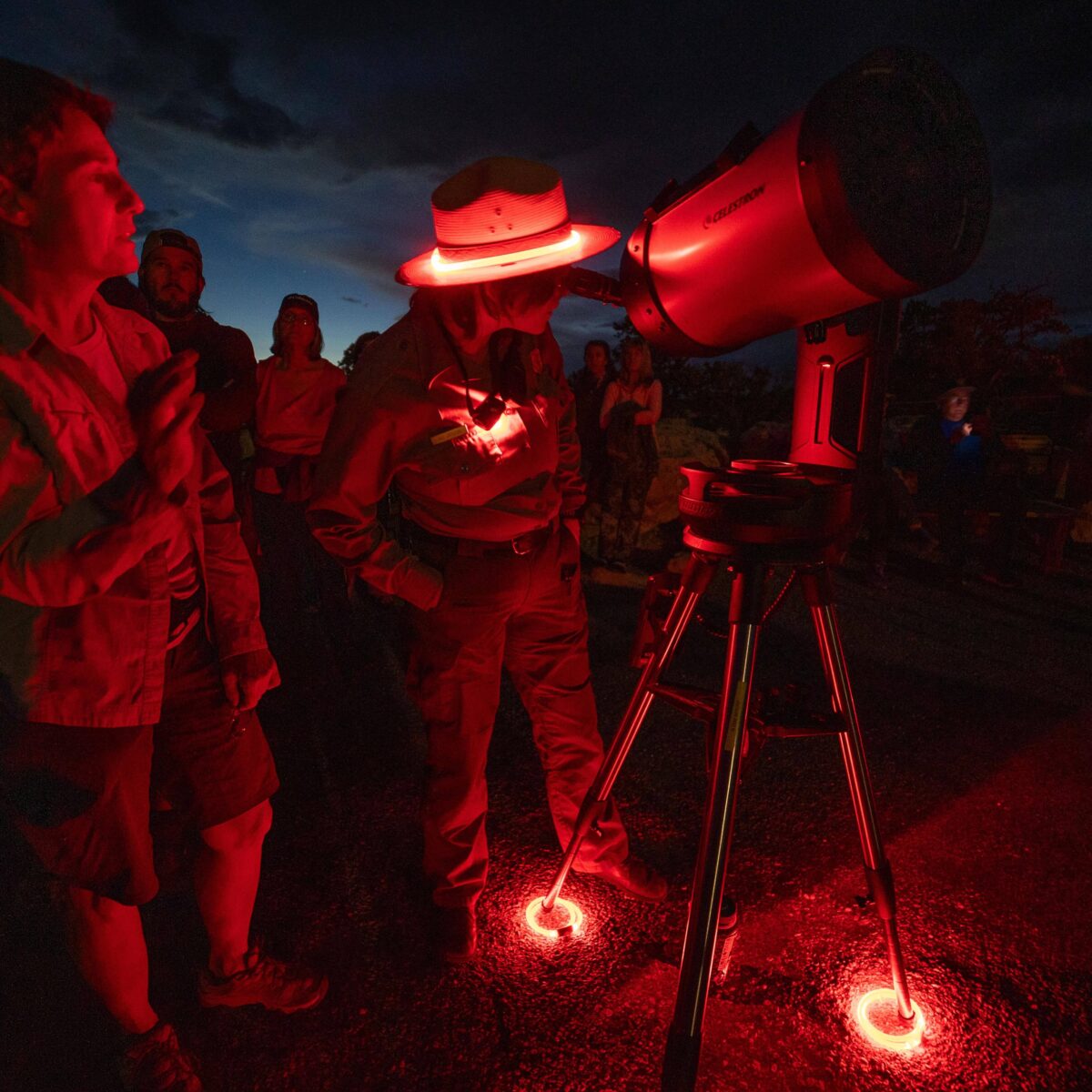 A park ranger gives a dark sky program and shows a visitor an object through a telescope. PC L/Cisneros