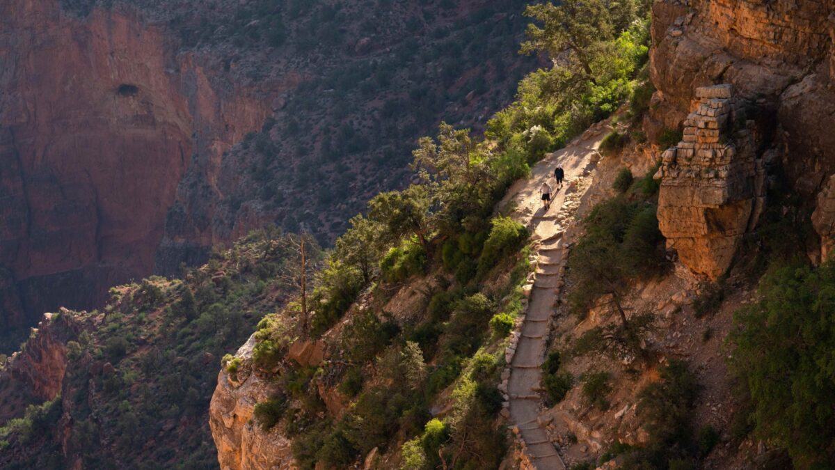 Two hikers descend the Bright Angel Trail