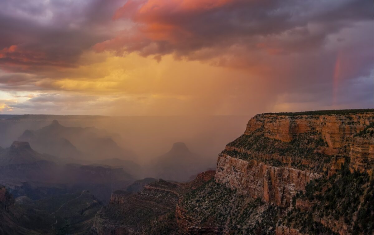 Colorful Sunset During Summer Monsoon Rain 1450 cropped
A summer monsoon sunset to remember, with a faint rainbow visible on the right, as seen from Grand Canyon Village. NPS file photo.