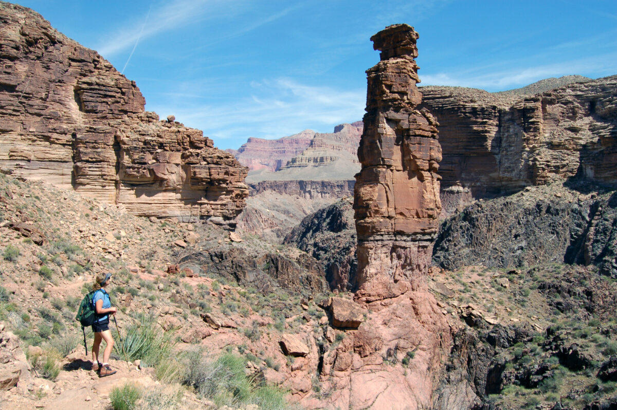 Backpacker viewing the Monument along the Tonto Trail, Grand Canyon National Park. Camera is pointed north. NPS Photo by Michael Quinn.