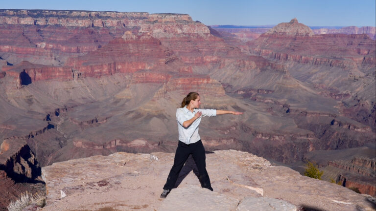 Woman dancing with Grand Canyon in the background
