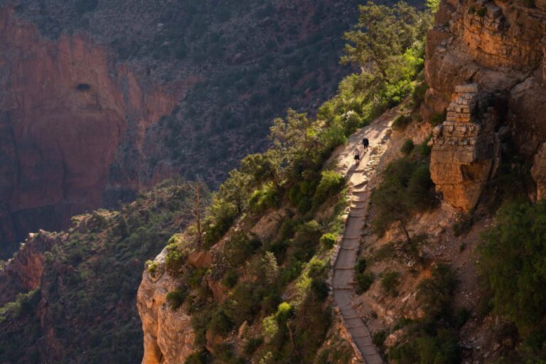 Two hikers descend the Bright Angel Trail