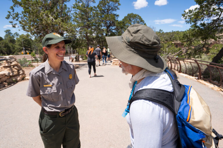 Smiling park ranger talking to a guest with a bucket hat PC David Wallace