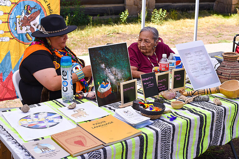 Autumn & her grandmother at the Kaibab Paiute demonstration table at Heritage Days 2023.