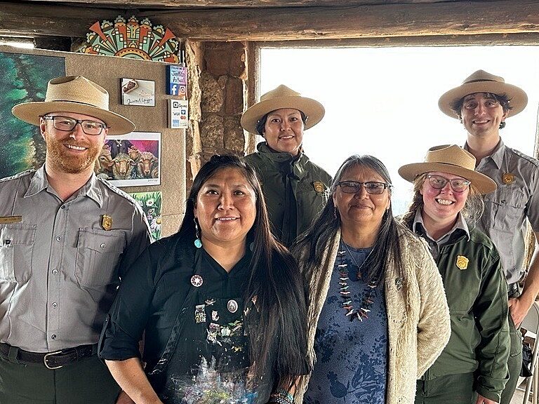 Grand Canyon rangers pose with cultural demonstrator and artist Janet Yazzie