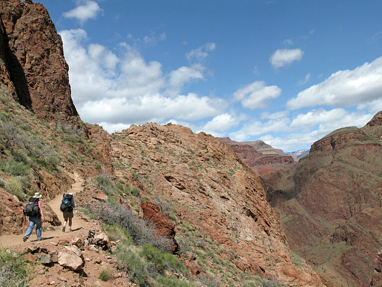 Hikers climbing out of the Pipe Creek drainage and reaching the top of the Devil's Corkscrew, below Indian Garden on the Bright Angel Trail, Grand Canyon National Park. NPS photo by Michael Quinn.