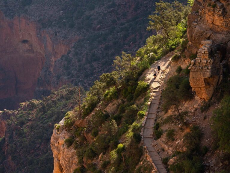 Two hikers descend the Bright Angel Trail