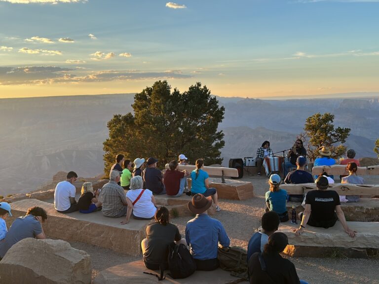 Visitors Enjoying a performance by Milton Tso on the Flute at Desert View Ampitheater.