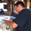 Damon Tso Jr smiling working on clay pottery
