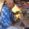 Duane Tawahongva working at table on jewelry piece