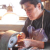 Duran Gasper using wheel to create jewelry piece