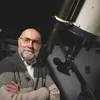 Dr. Dan Fleisch poses with a telescope