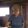 Henry Nez standing in front of glass table in stone building