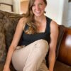 Portrait of Erin Reynolds sitting on a couch.