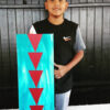 Kyle Yazzie standing with artwork