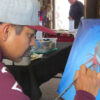 Nathan Begay with paintbrush in hand