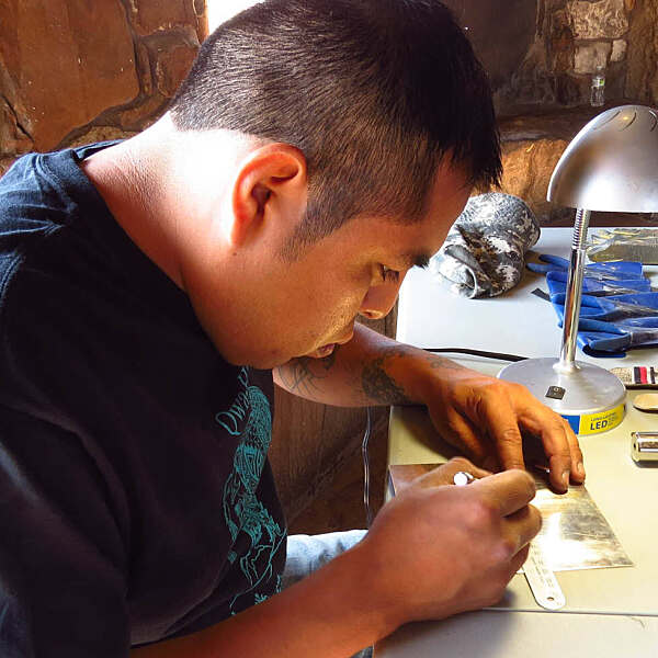 Cordell Sakeva inspecting and working on jewelry