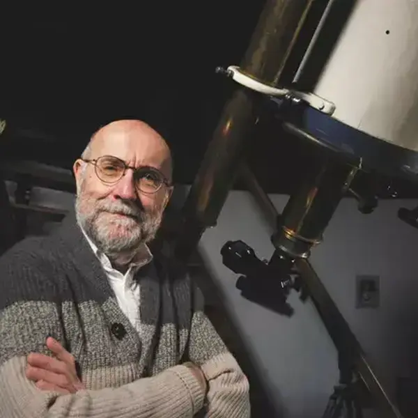 Dr. Dan Fleisch poses with a telescope