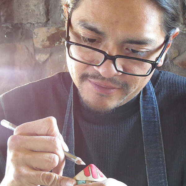 Greg Hill painting wood toy top