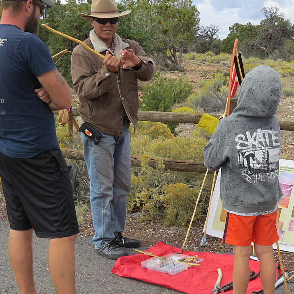 Jason Nez demonstrating technique with young boy
