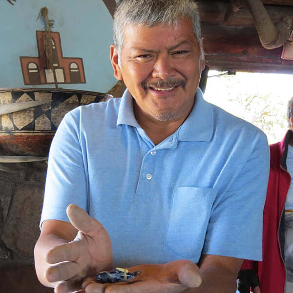 Jimmy Yawakia holding small carving