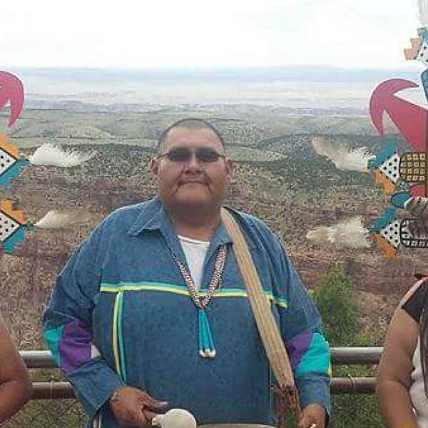 Merle Namoki wearing drum standing in front of canyon