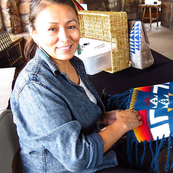 Michelle Silver holding clothing piece smiling
