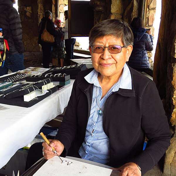 Ola Eriacho smiling sitting with jewelry