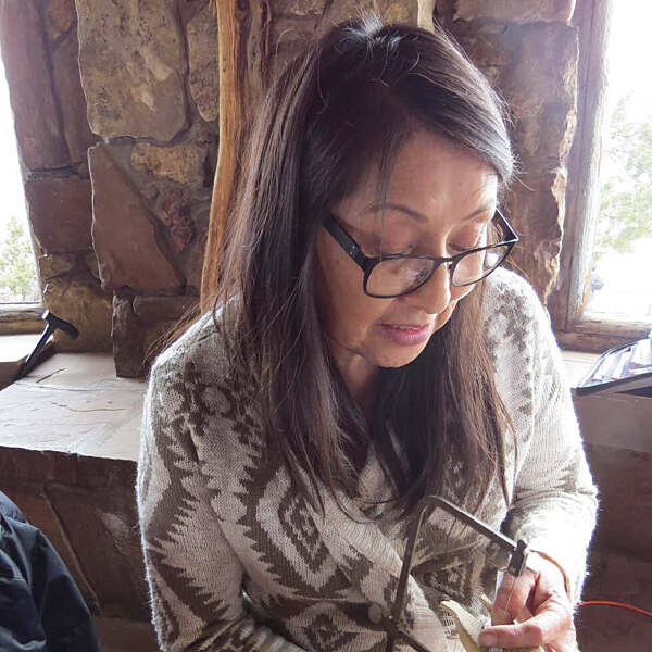 Rosabelle Shepard sitting working on jewelry piece