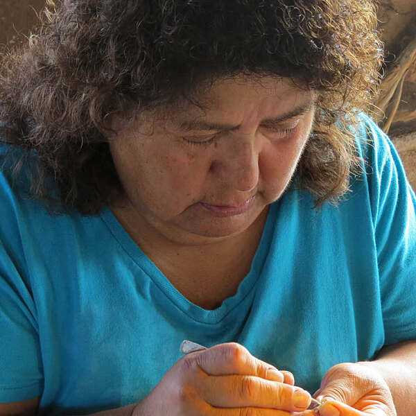 Roxanne Seoutewa working closely with small jewelry piece