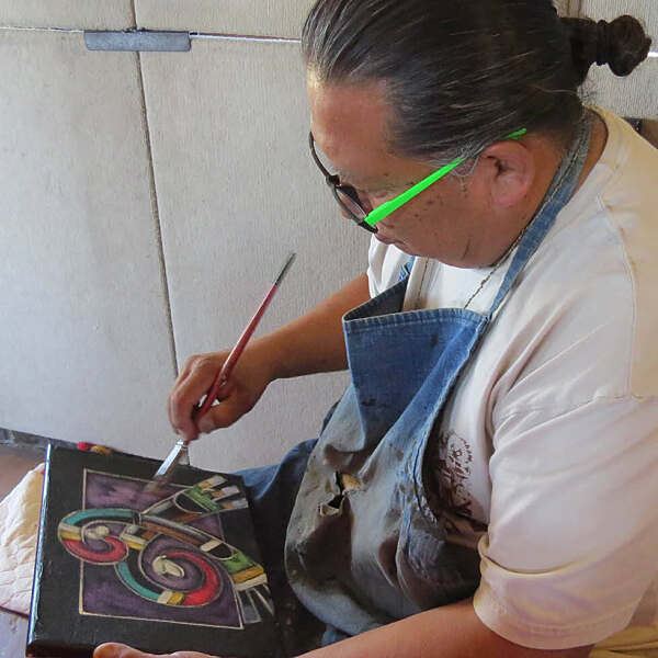 Kevin Horace Quannie working on artwork