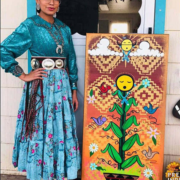 Penelope Joe standing next to artwork