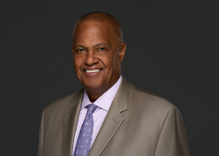 Photo of Dennis A. Johnson in business suit.